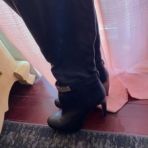 Black heeled boots with gold buckle